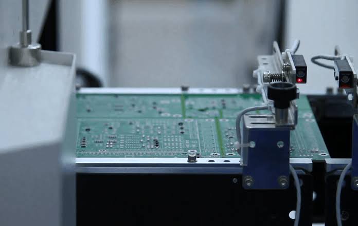 Automated SMT pick-and-place machine assembling a circuit board